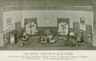 Black and White picture shows a scene on stage of a waiting room of a hotel.