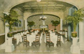 Colorized photograph of a tables set in a formal hotel dining room.