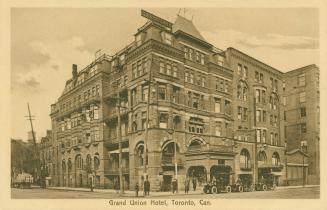 Sepia toned photograph of a very large, Victorian hotel.