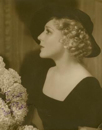 Profile picture of Mary Pickford wearing a black dress and hat.