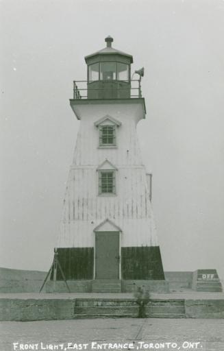A four-storey white wooden lighthouse.