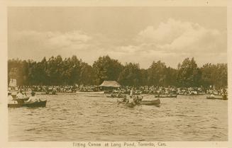Sepia toned picture of people in canoes on a pond.