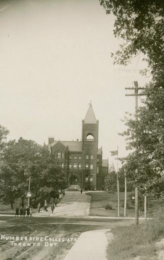 Black and white photograph of a high school building with a bell tower.