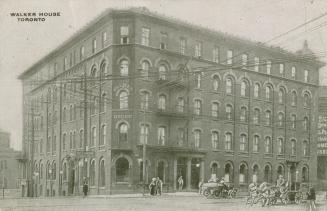 Black and white photo postcard of Walker House Hotel, Toronto. Exterior view. With a few people ...