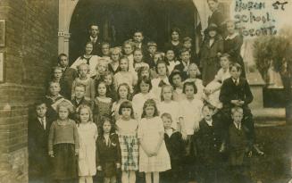 Black and white photograph of a large group of school children or different ages and their teac ...