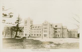 Black and white picture of a large, gothic-Tudor style building.