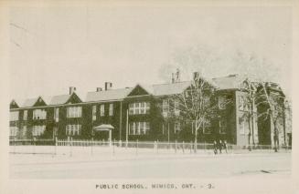 Black and white photograph of a large. two story school.