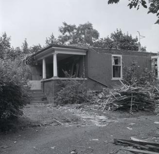 Image shows a house with some trees around it.