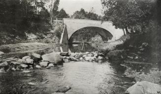 Image shows a river view with the bridge across it.
