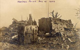 Black and white photograph of the remains of a building after a fire.
