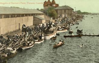 Colorized photograph of row boats and crowd standing on a boardwalk.