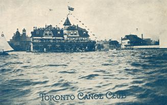 Sepia toned photograph of a large Victorian club house on the edge of a lake.