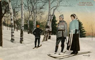 Three people skiing in a park.