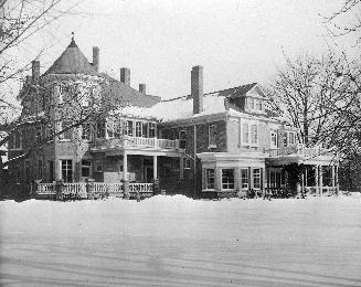 A photograph of a house during winter.