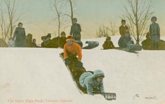 Large group of people tobogganing in a park.