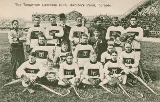 Black and white photo postcard of the Tecumseh Lacrosse Club, showing 19 members sitting in a g ...