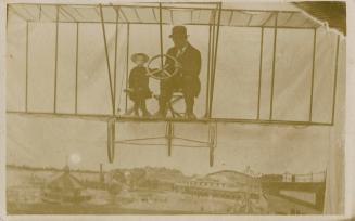 Black and white photo montage of a boy and dad on an early, open airplane. Superimposed montage ...