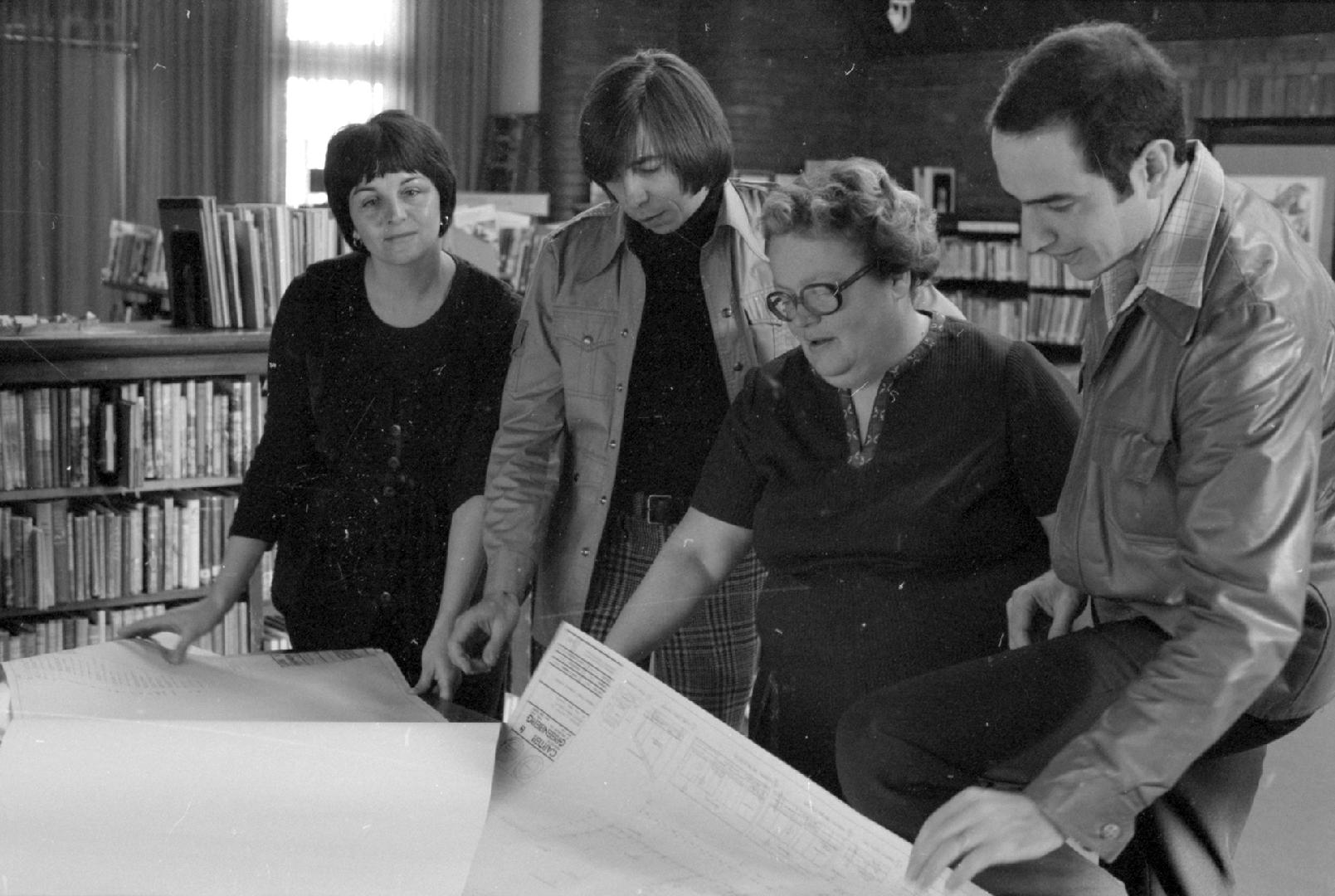 Sheila Blinoff of the Ward 9 Community News, architect Phil Carter, citizen advisor Ann Doherty and architect Ken Greenberg look at plans for Eastern Branch