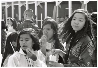 A photograph of a group of spectators at an outdoor event in downtown Toronto