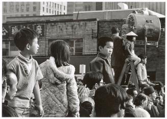 A photograph of a group of spectators at an outdoor event in downtown Toronto.
