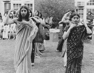 Girls wearing saris dancing