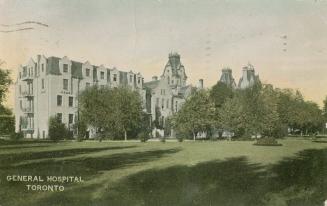 Color picture of a large, light colored hospital complex with a huge front lawn.