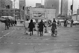 A photograph of a group of pedestrians crossing a street.
