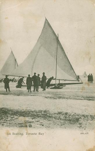 Several men standing in from of an ice boat on a frozen body of water.