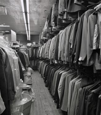 Hollywood Jobbers, 306 Queen St. West, three-tiered racks at back of store, 1984.