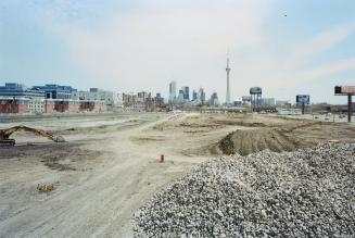 A photograph of a construction site, with a pile of rubble in the foreground and the Toronto sk ...