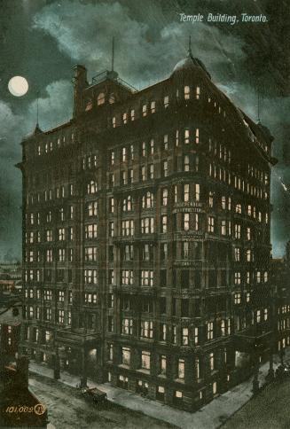 Colorized photograph of a large, Victorian office building at night. Full moon.