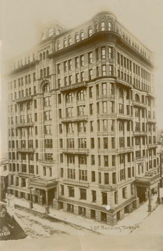 Black and white photograph of a large, Victorian office building.