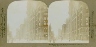 Pictures show a busy city street lined with tall buildings.