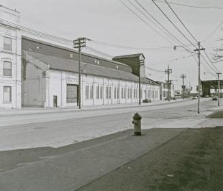 A photograph of a building with a sign reading &quot;Bathurst Tool Ltd.&quot; on the left side  ...