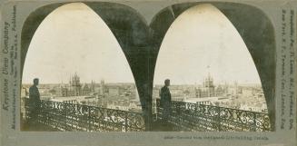 Pictures show the silhouette of a man standing on a balcony with a iron rail, looking out at th ...