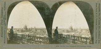 Pictures show the silhouette of a man standing on a balcony with a iron rail, looking out at th…