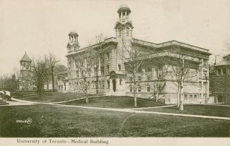 Black and white picture of a very large school building with two towers.