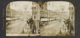 Pictures show a busy downtown street with buildings on either side and a streetcar.