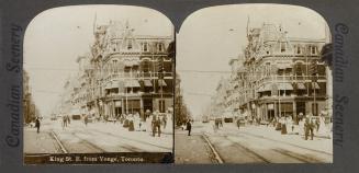 Pictures show a busy city street with large buildings on either side of it.