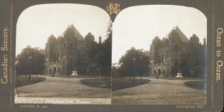Pictures show a huge Romanesque government building with towers.
