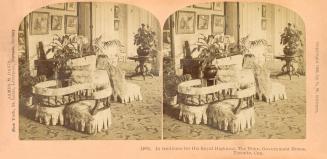 Pictures show an interior of a living room with chairs upholstered in chintz.