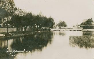 Black and white photograph of a lagoon with a large building to the right.