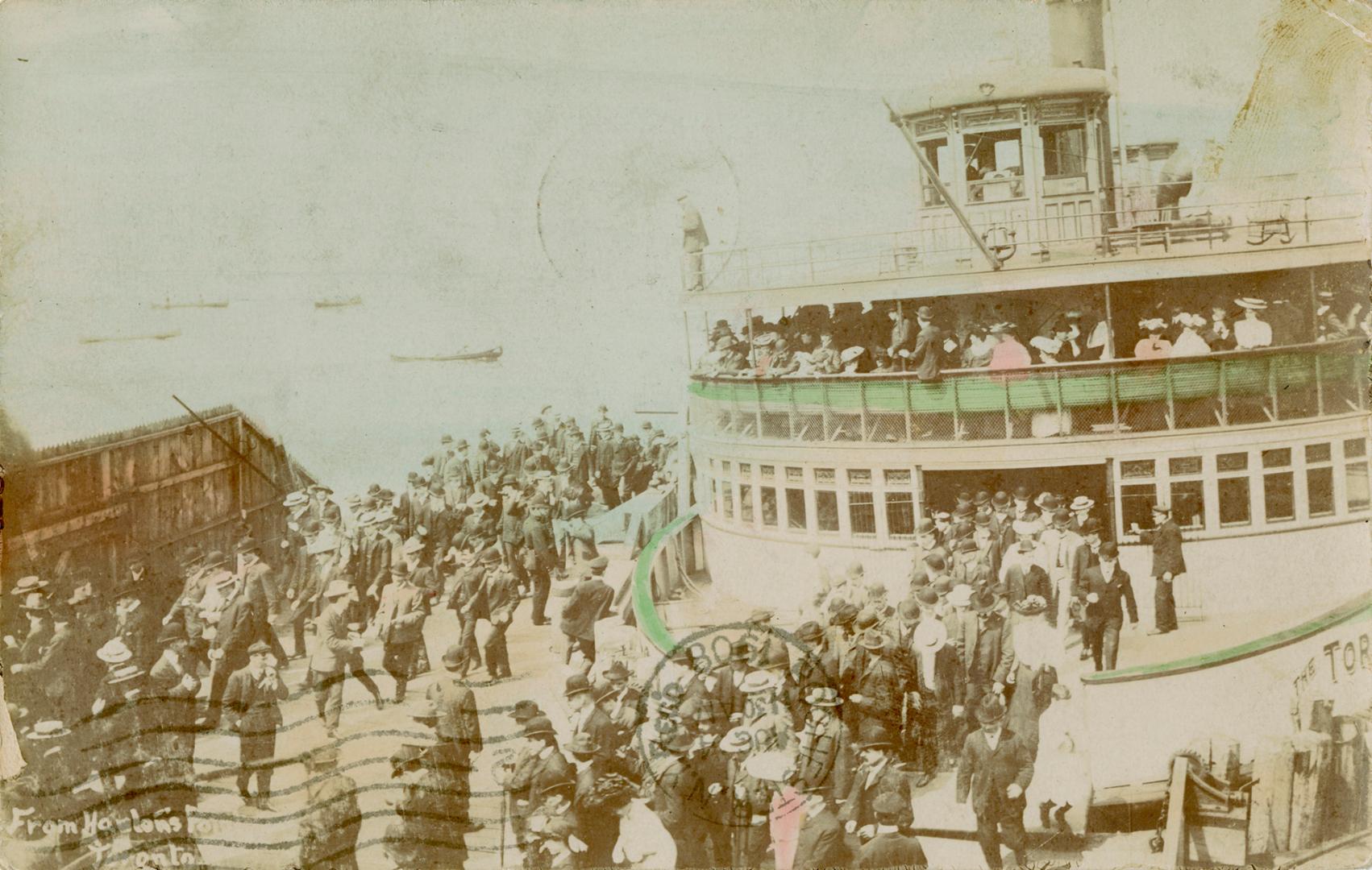 Colorized photograph of a ferry docked and passengers disembarking.