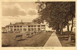 Sepia toned photograph of a large Victorian structure with verandah on manicured grounds.