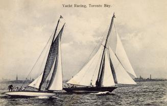 Black and white photograph of two sailboats on a lake. 