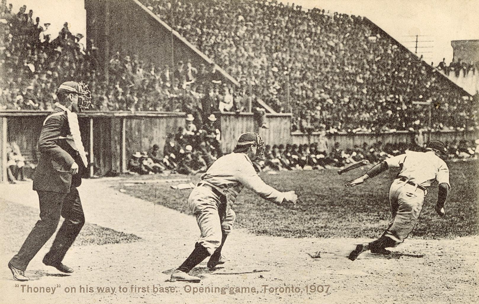 Black and white picture of a crowd watching baseball; umpire, catcher and batter.