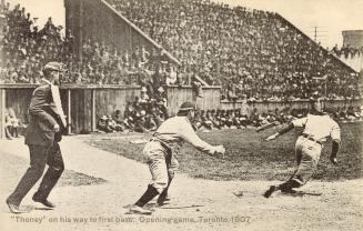 Black and white picture of a crowd watching baseball; umpire, catcher and batter.
