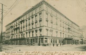 Black and white photograph of a five story hotel building taken from the corner