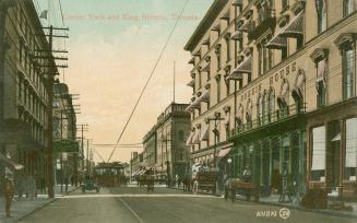 Colorized photograph of a downtown street with multistory buildings on each side.