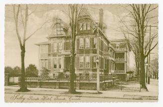 Black and white photograph of a Queen Anne style mansion.